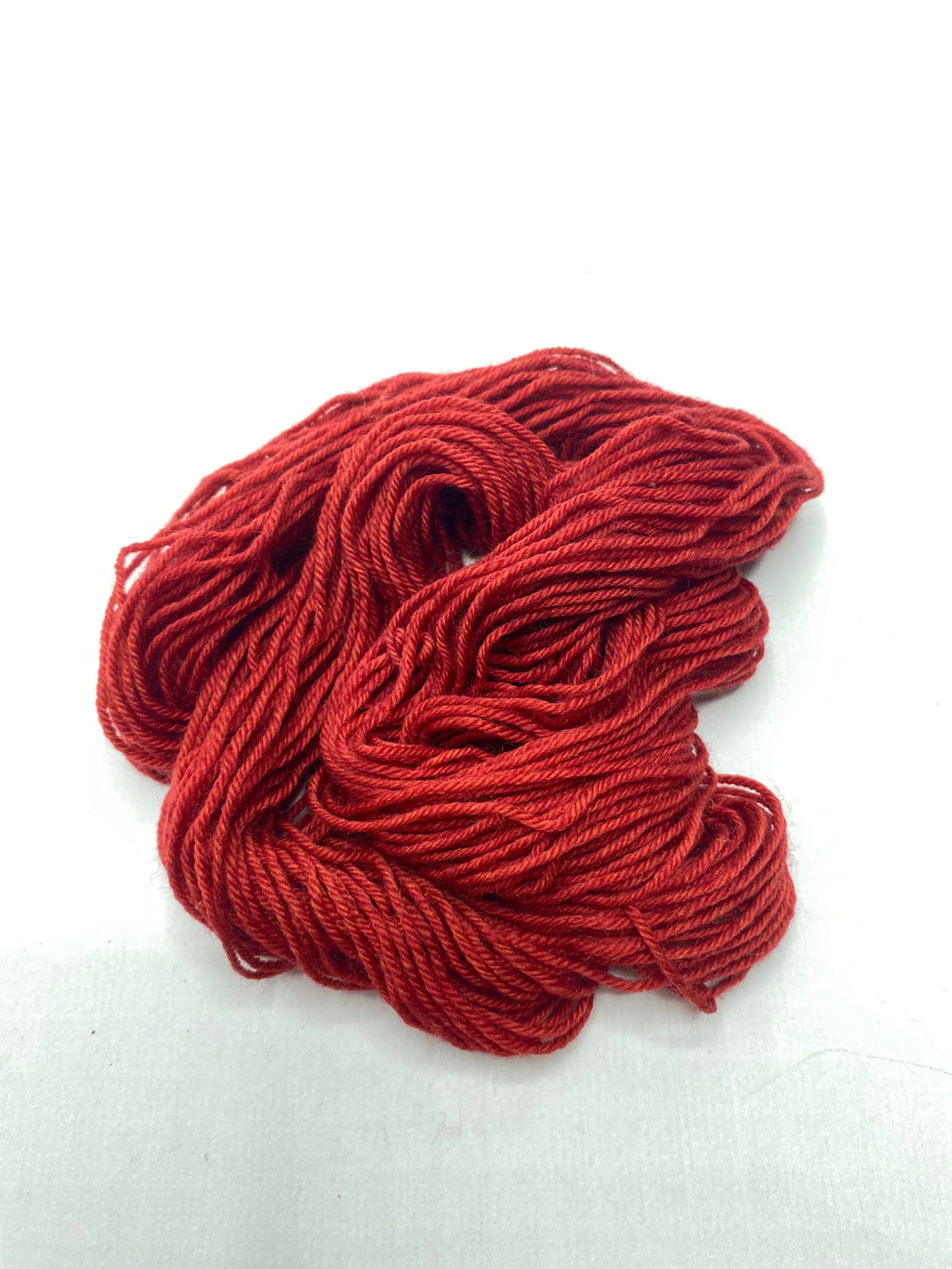 Red yarn skein on a white background