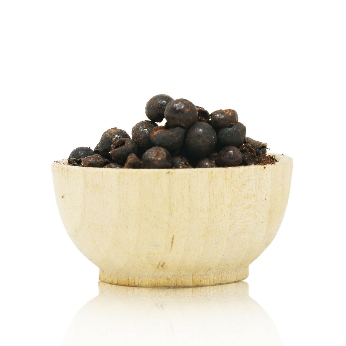 Wooden bowl filled with dark berries on a white background