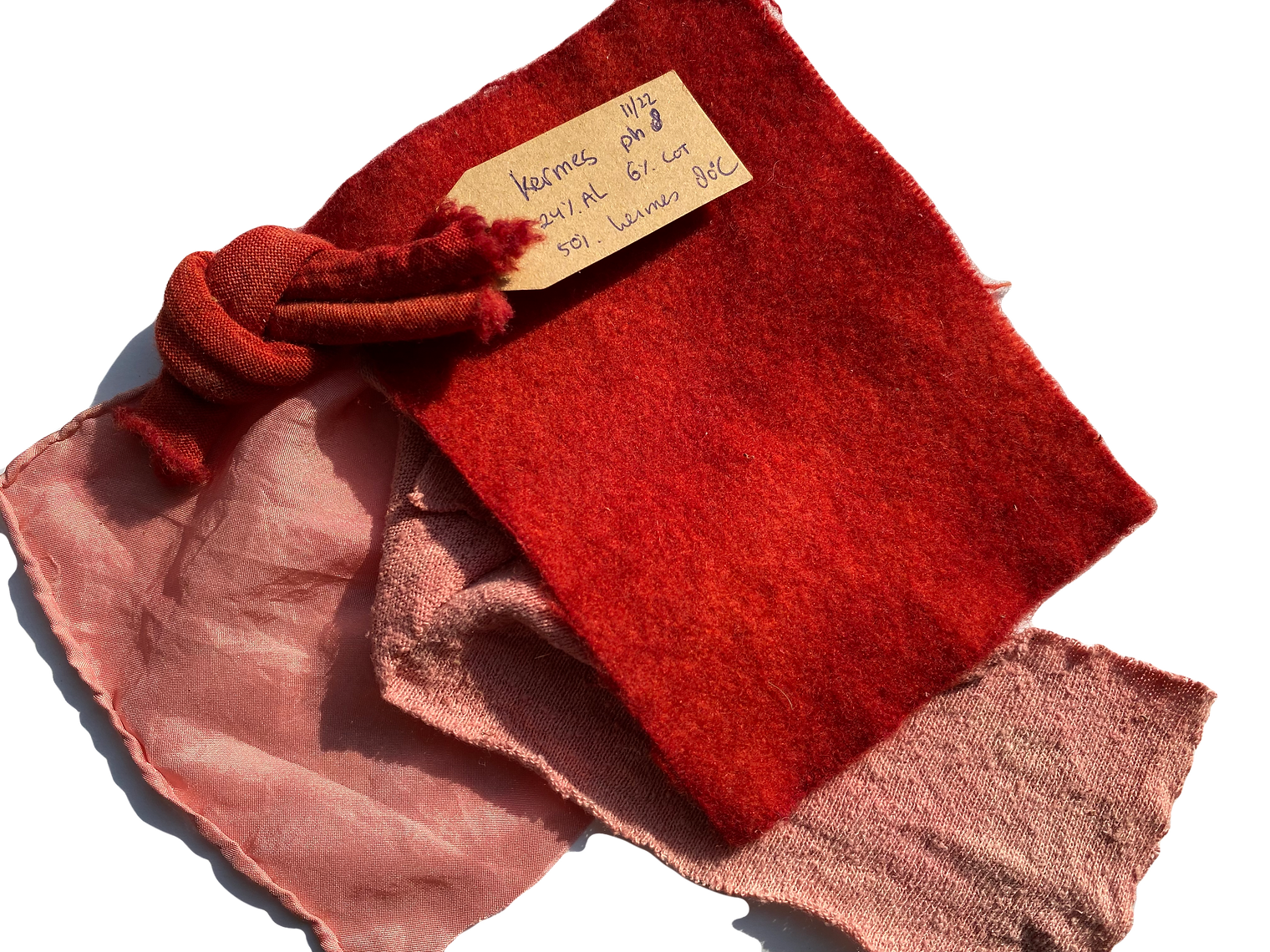 Red fabric with a tag on a white background