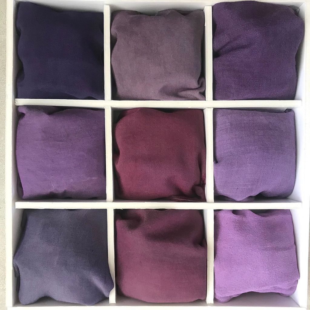 Nine purple fabric swatches dyed Logwood Extract (Haematoxylum campechianum) arranged in a 3x3 grid.