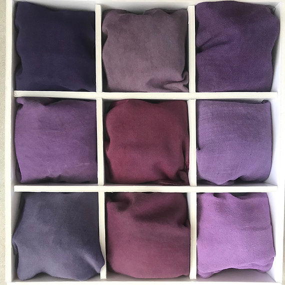 Nine purple fabric swatches arranged in a 3x3 grid.