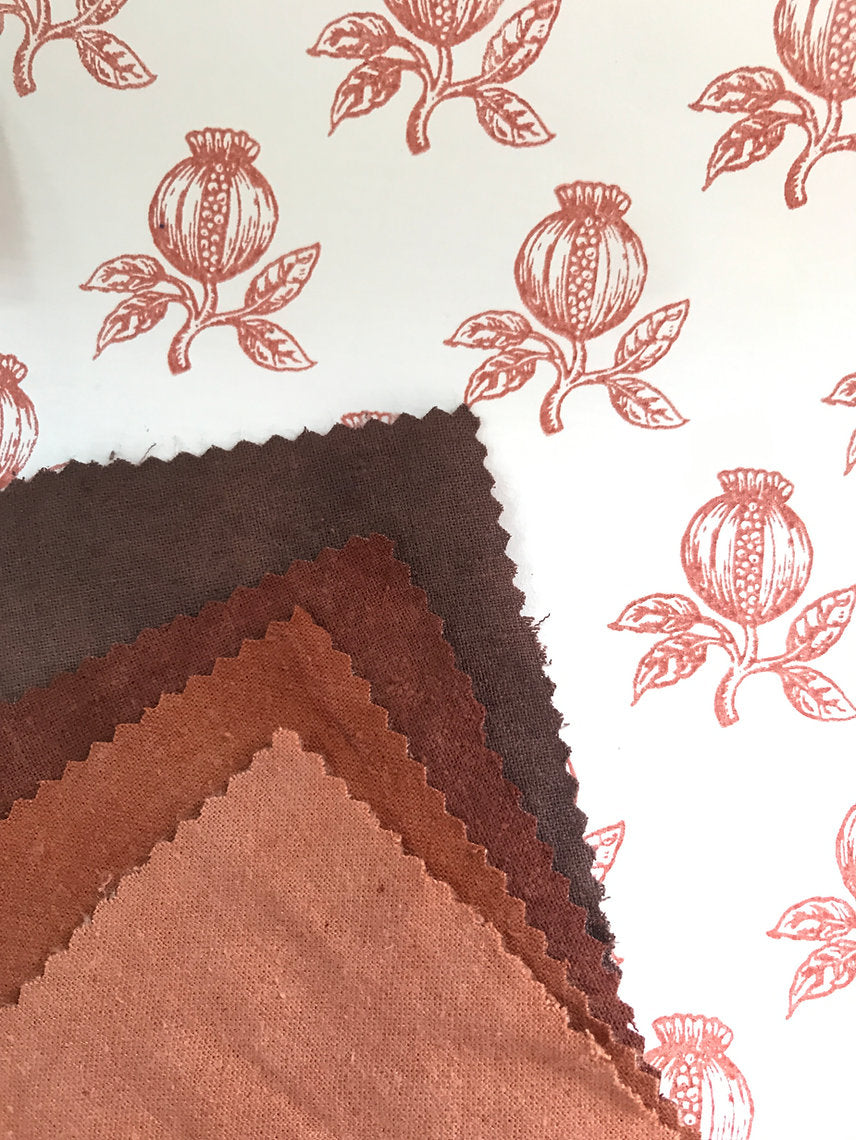 Fabric swatches in brown tones with a floral pattern in the background