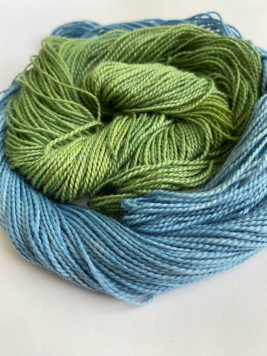 Green and blue skein of yarn on a white background