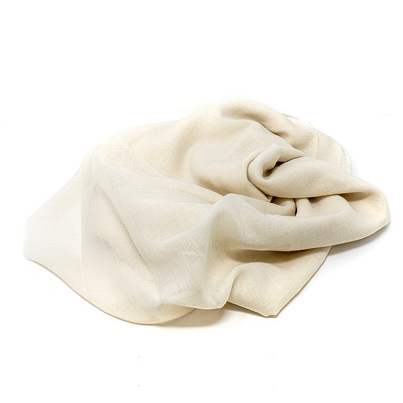 Folded cream-colored fabric on a white background