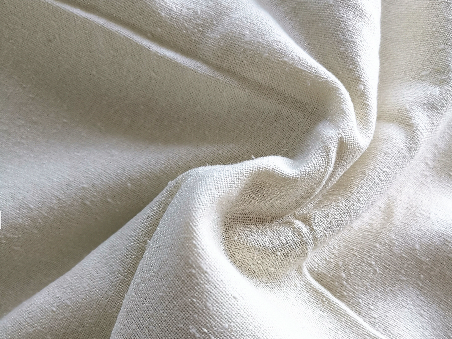Close-up of beige silk woven fabric with soft texture