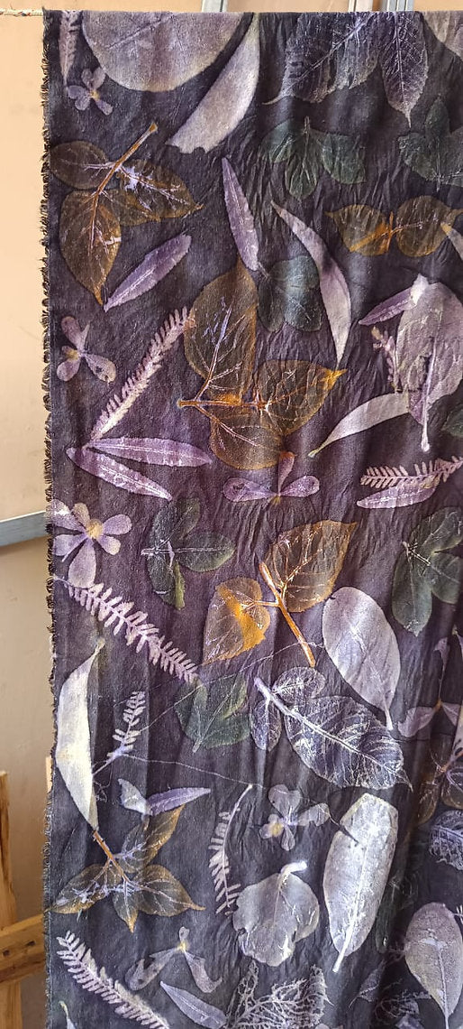 Scarf with floral and leaf patterns on a dark background