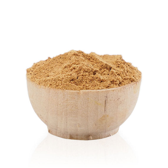 Brown powder in a wooden bowl on a white background