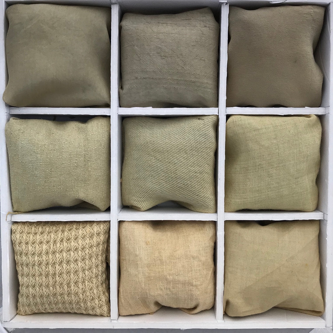 Nine squarefabrics dyed Poplar Bark (Populus nigra) in various beige and brown tones arranged in a grid on a white background.