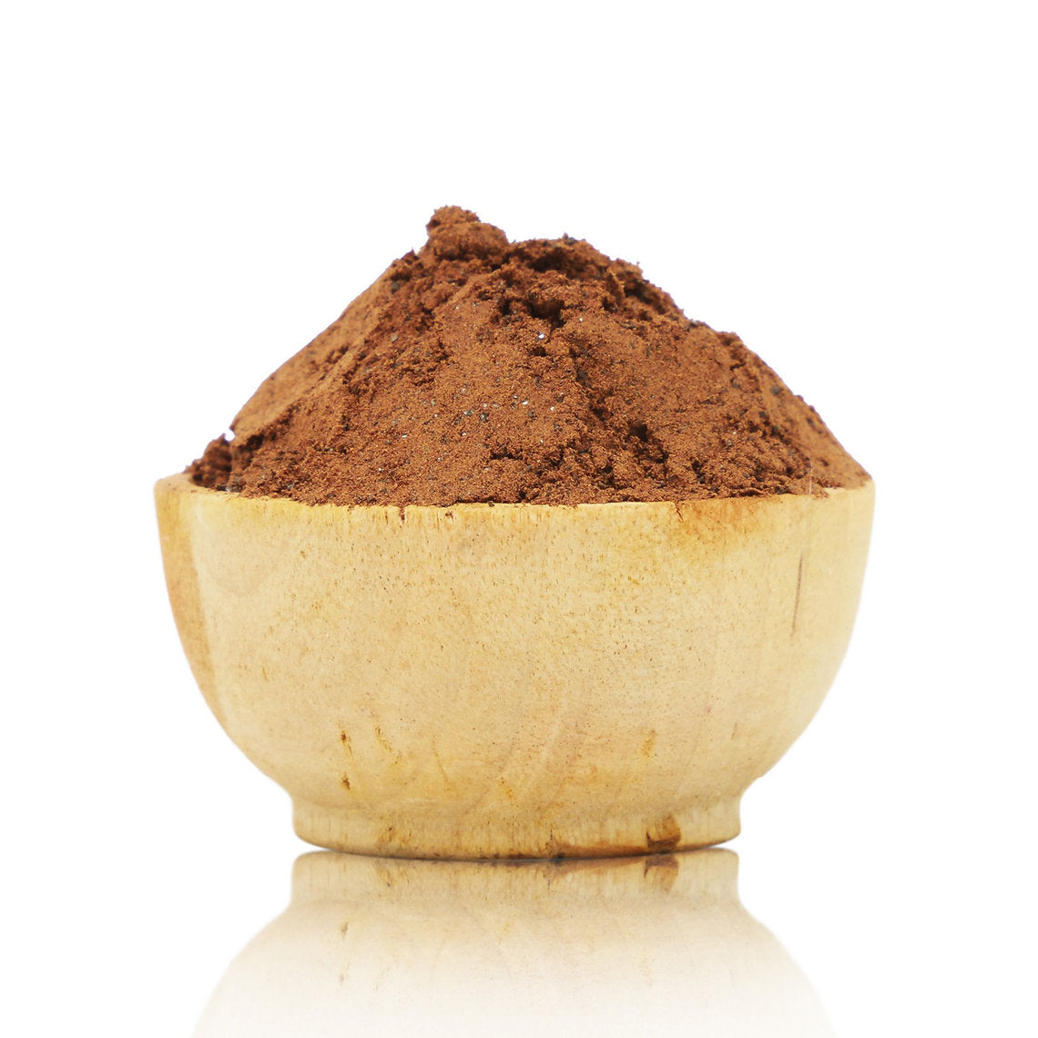 Wooden bowl filled with brown powder on a white background