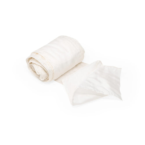 White fabric roll and folded sheet on a white background