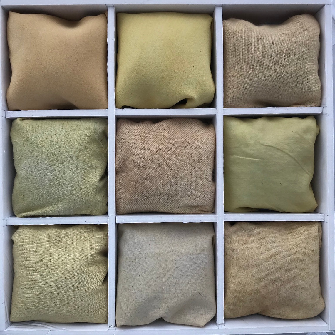 Nine square fabrics dyed Sorrel Pieces (Rumex acetosa) in beige and green colors arranged in a grid on a white background.