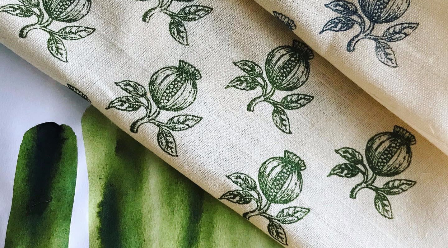 Fabric with green floral pattern on a white background