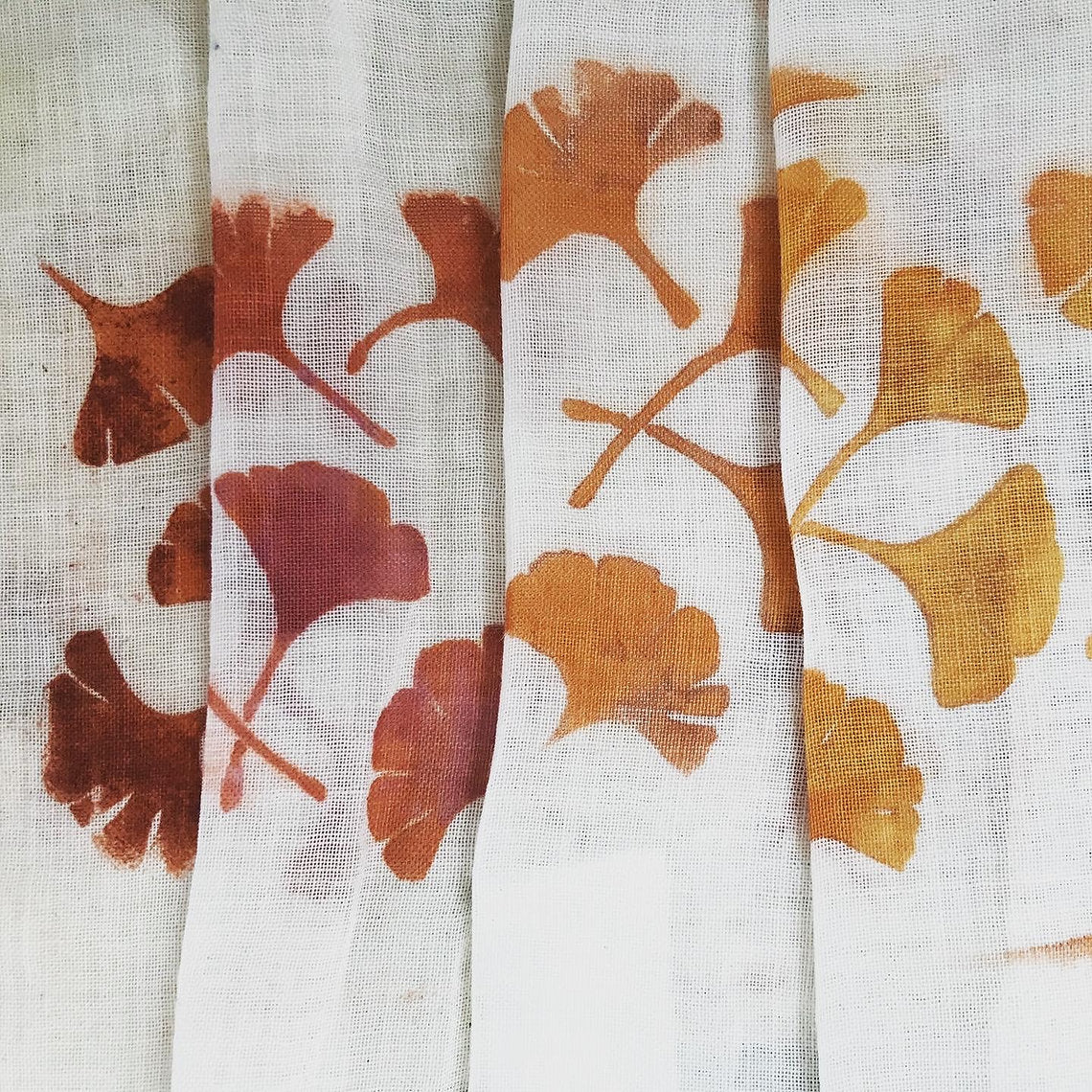 Three fabric swatches with brown and orange leaf patterns on a white background