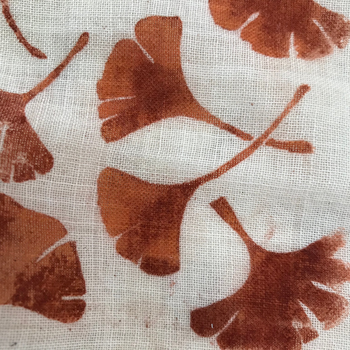 Brown leaf pattern on a textured beige background