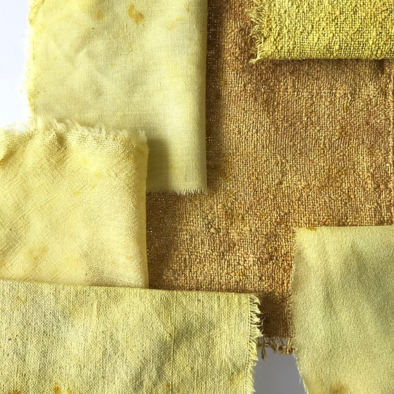 Close-up of fabric swatches in yellow and brown tones.