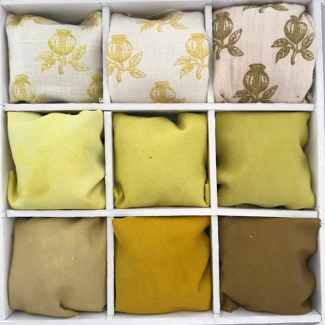 Set of fabric samples in a grid with floral patterns and solid colors.