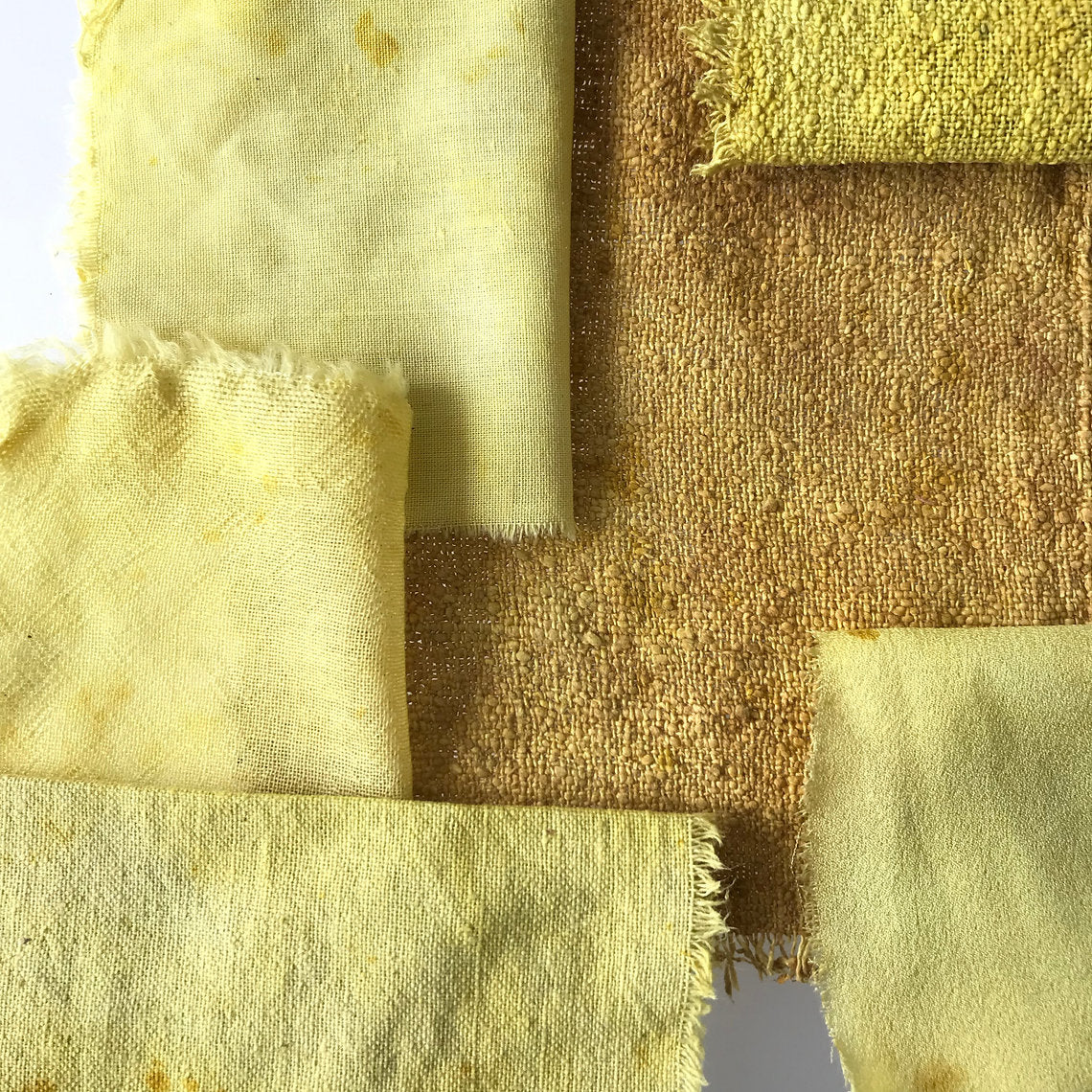 Close-up of various textured yellow and brown fabric swatches.