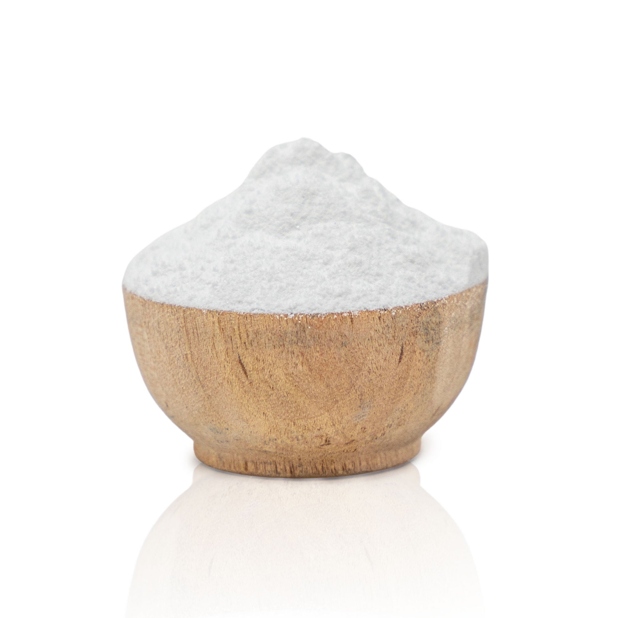 Wooden bowl filled with white salt on a white background